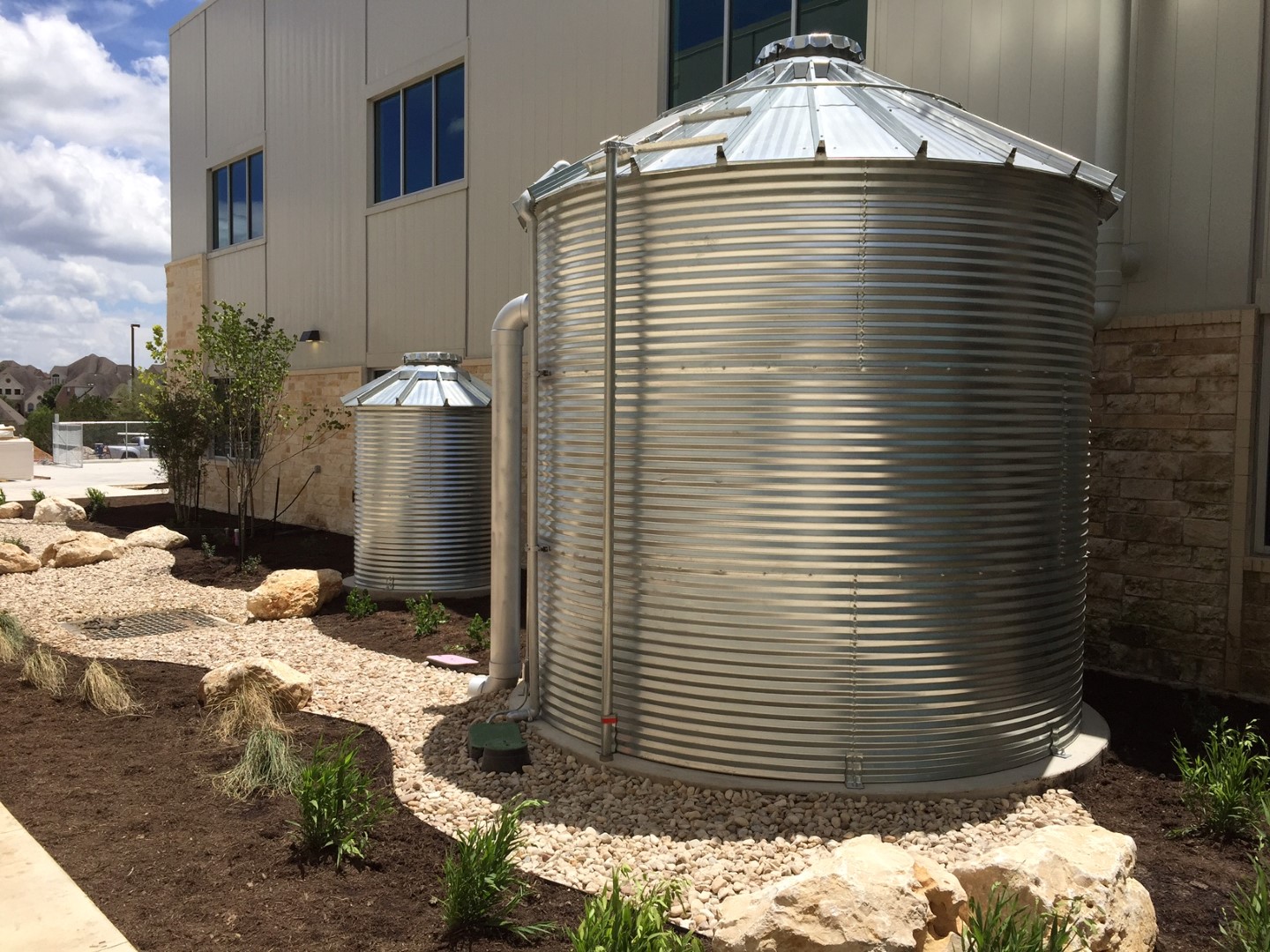 View of 10,000-gallon metal cistern and pump enclosure for irrigation system.